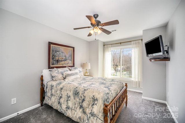 bedroom featuring visible vents, dark carpet, baseboards, and ceiling fan