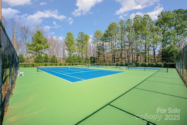 view of tennis court with fence