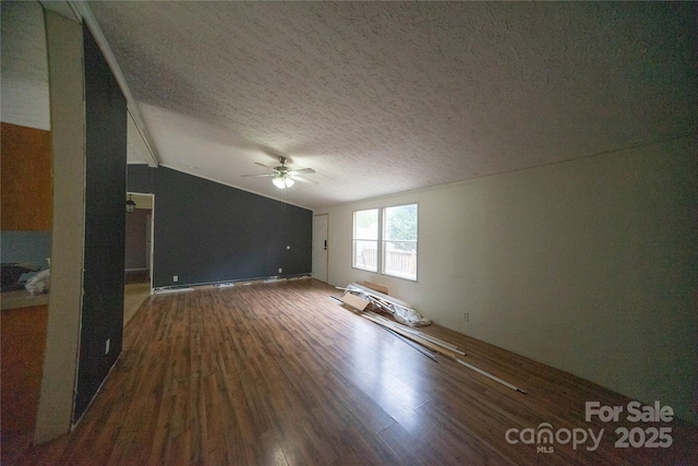 unfurnished living room featuring ceiling fan, dark wood-type flooring, a textured ceiling, and vaulted ceiling