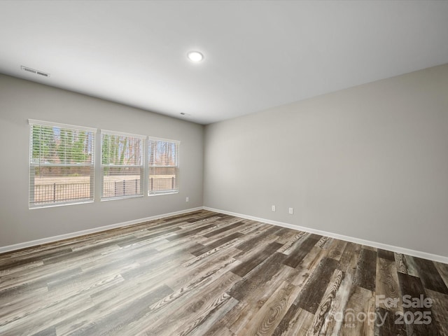 spare room with hardwood / wood-style flooring