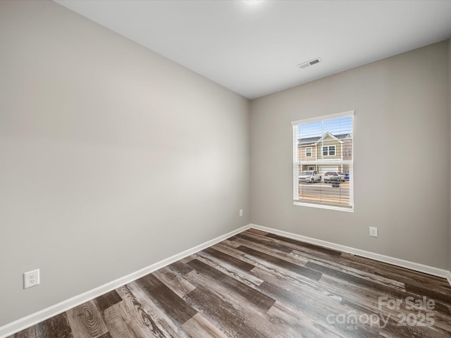 spare room featuring dark hardwood / wood-style floors