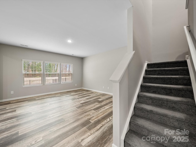 stairway featuring hardwood / wood-style floors