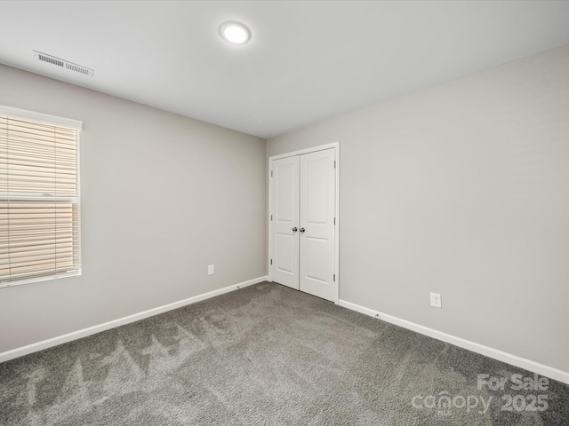 carpeted spare room featuring plenty of natural light