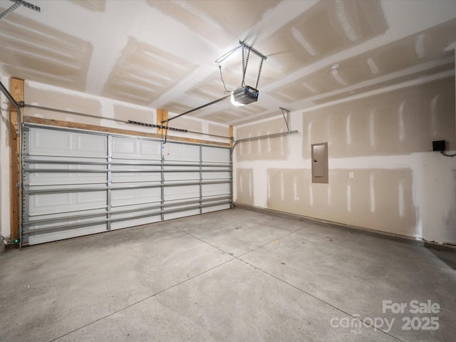 garage with a garage door opener and electric panel