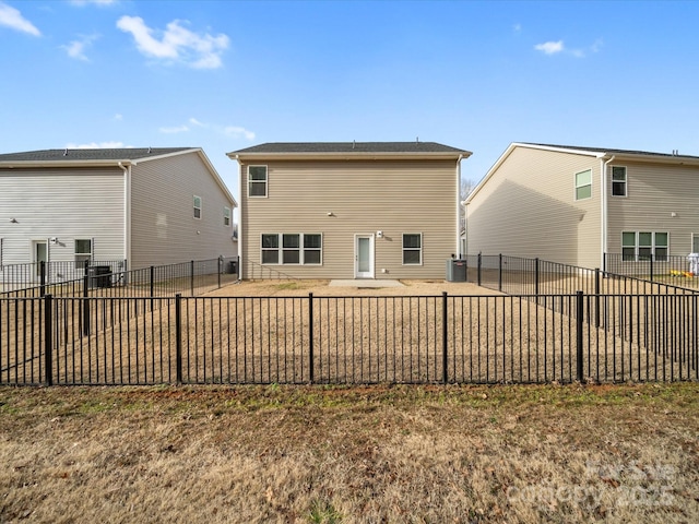 rear view of house with central AC and a patio area