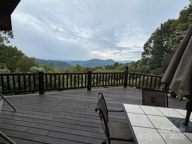 wooden terrace with a mountain view