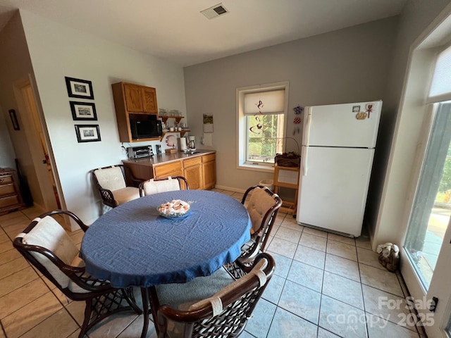 dining space with light tile patterned flooring and sink