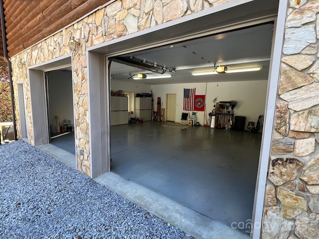 garage featuring a garage door opener and fridge