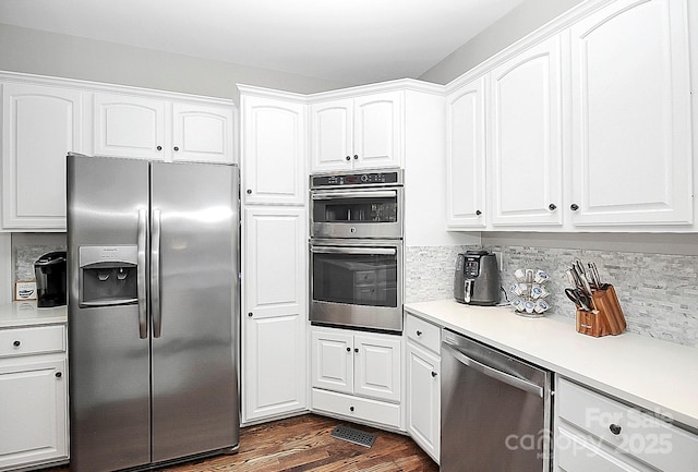 kitchen featuring white cabinetry, dark hardwood / wood-style flooring, and stainless steel appliances