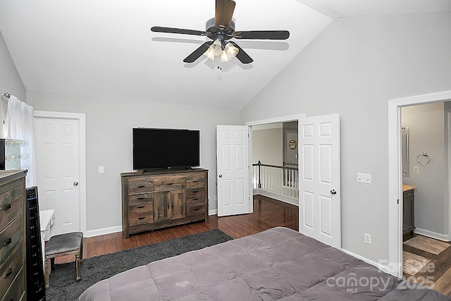 bedroom with high vaulted ceiling, dark hardwood / wood-style floors, connected bathroom, and ceiling fan