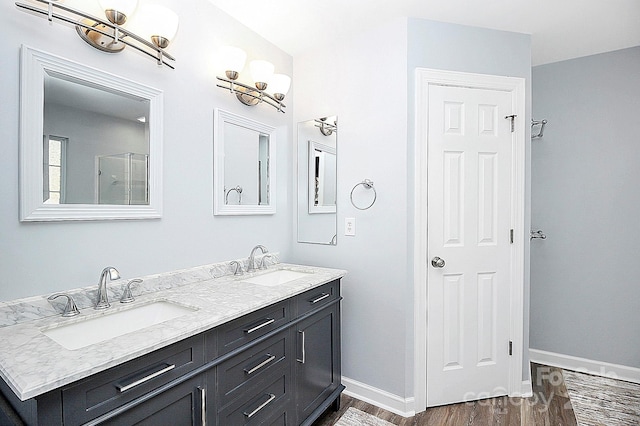 bathroom with vanity and hardwood / wood-style flooring