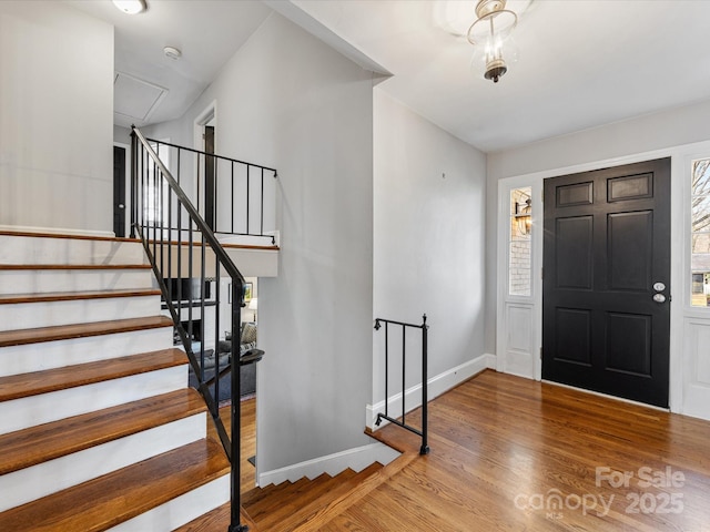 entryway with baseboards and wood finished floors