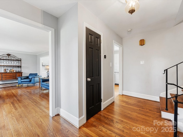 hallway with baseboards and wood finished floors