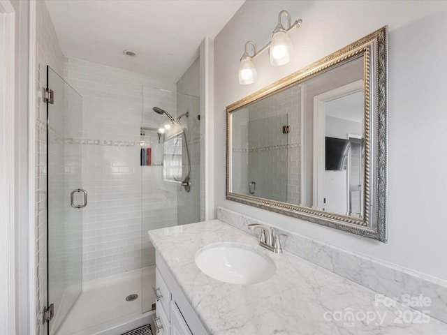 bathroom featuring a shower stall and vanity