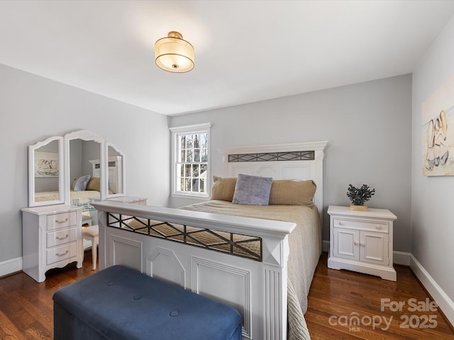 bedroom featuring dark wood-type flooring and baseboards