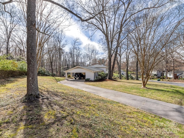 view of front of home featuring a front yard and concrete driveway