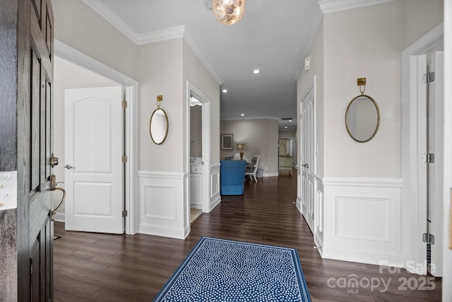 entryway featuring dark wood-style floors, ornamental molding, wainscoting, and recessed lighting