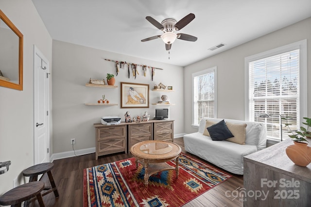 office space featuring a ceiling fan, dark wood-style flooring, visible vents, and baseboards