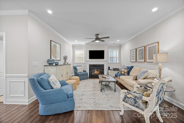 living room with a glass covered fireplace, dark wood finished floors, baseboards, and recessed lighting