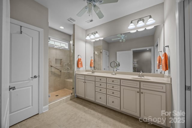 full bathroom featuring tile patterned floors, a sink, visible vents, and a shower stall