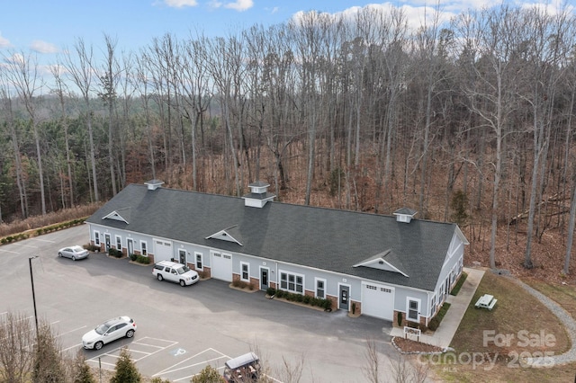 bird's eye view with a wooded view