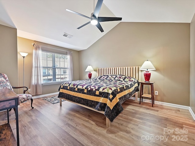 bedroom featuring ceiling fan, lofted ceiling, and hardwood / wood-style floors