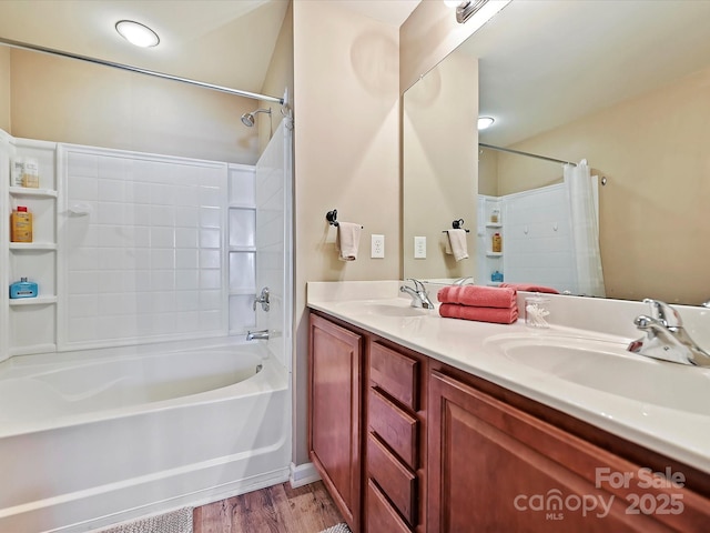 bathroom featuring hardwood / wood-style flooring, vanity, and bathtub / shower combination