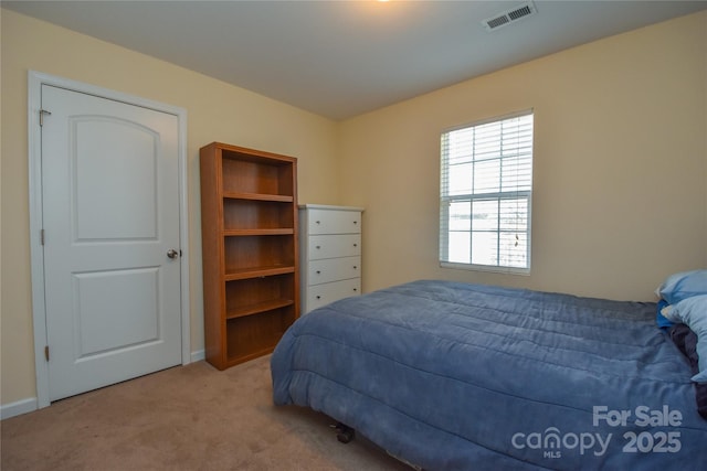 bedroom featuring light carpet