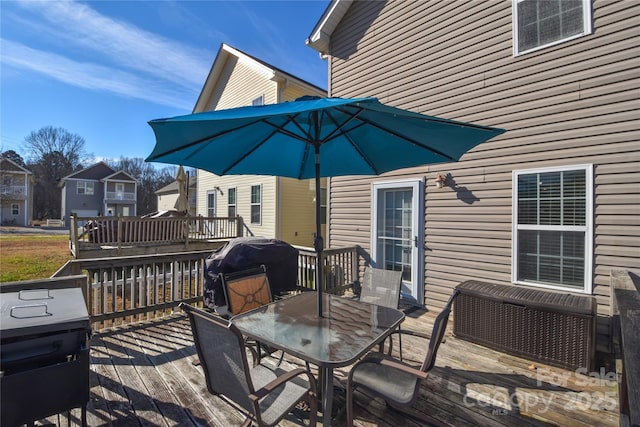 deck featuring area for grilling and outdoor dining space