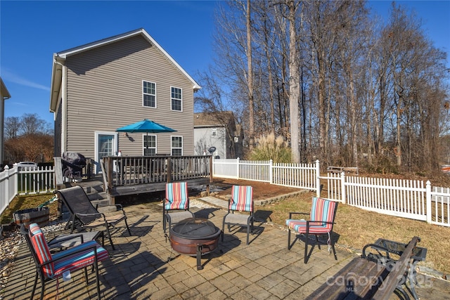 view of patio featuring an outdoor fire pit and a wooden deck