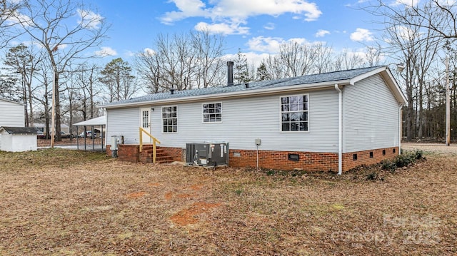 rear view of house with a carport and central AC