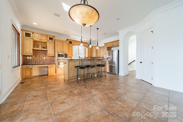 kitchen with pendant lighting, a kitchen breakfast bar, decorative backsplash, a center island, and stainless steel appliances