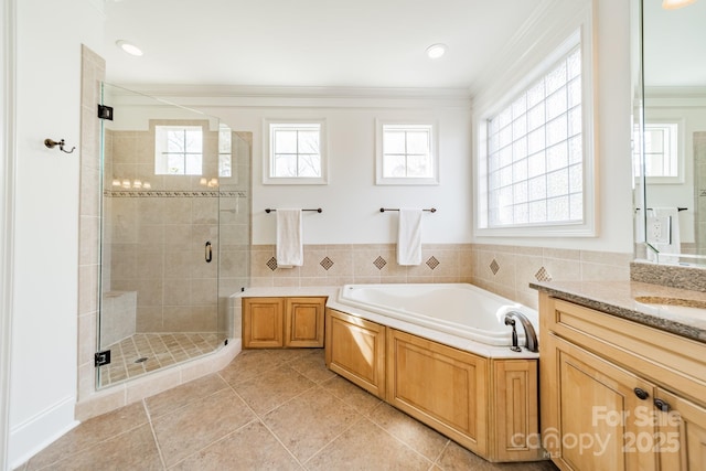 bathroom featuring vanity, a wealth of natural light, ornamental molding, and independent shower and bath