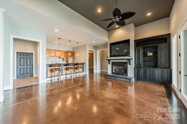 unfurnished living room with ceiling fan