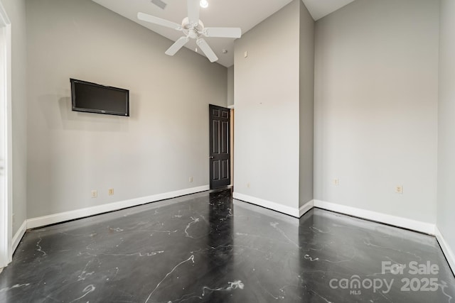 empty room with high vaulted ceiling and ceiling fan