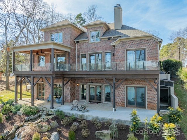 rear view of house featuring a patio, a balcony, ceiling fan, and french doors