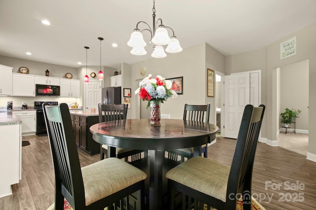 dining room with an inviting chandelier and dark hardwood / wood-style floors