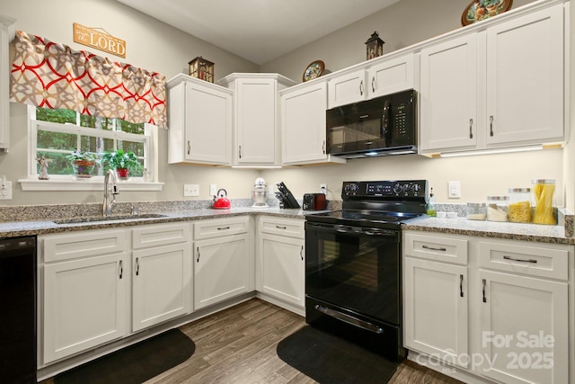 kitchen featuring sink, white cabinetry, dark hardwood / wood-style floors, light stone countertops, and black appliances