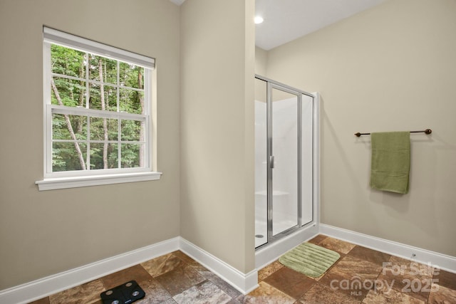 bathroom featuring a shower with shower door