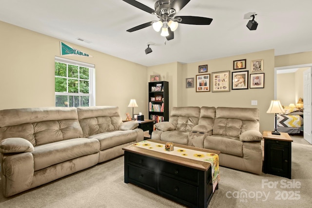 living room featuring light carpet and ceiling fan