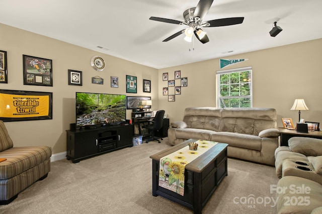 living room featuring ceiling fan and light colored carpet