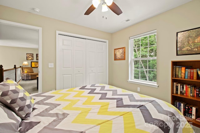 bedroom with ceiling fan and a closet