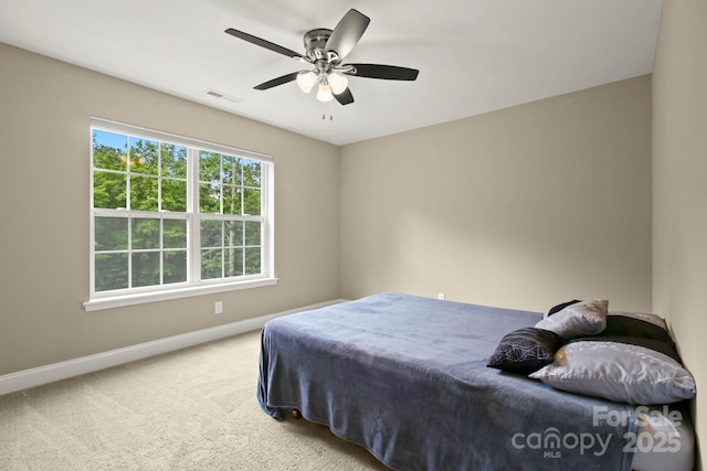 bedroom featuring ceiling fan and carpet