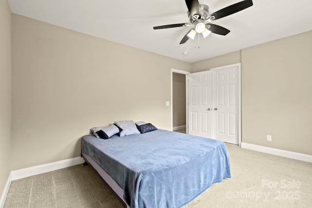 carpeted bedroom with a closet and ceiling fan