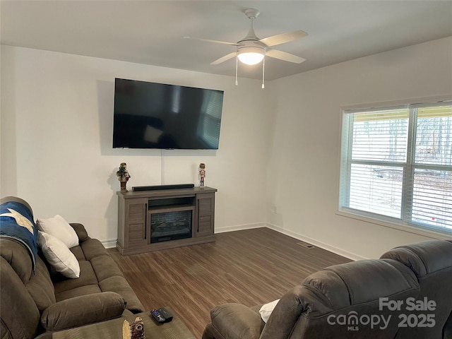 living room with dark hardwood / wood-style floors and ceiling fan