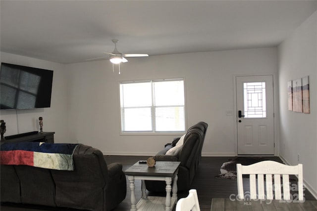 living room featuring ceiling fan, dark hardwood / wood-style floors, and a healthy amount of sunlight