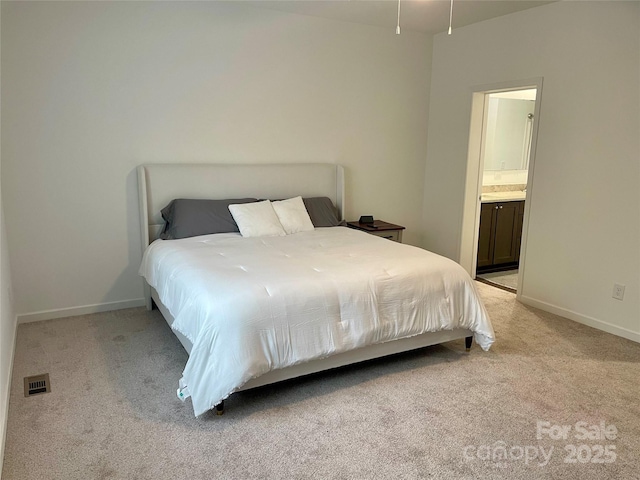 carpeted bedroom featuring connected bathroom