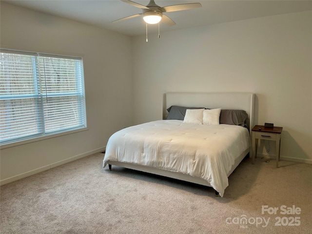 bedroom featuring ceiling fan and light carpet