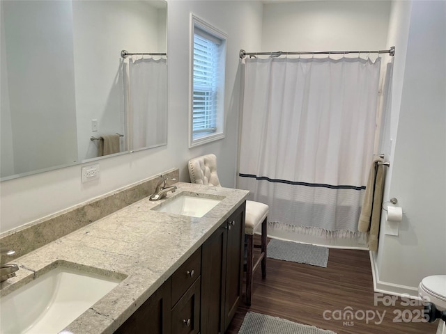 bathroom with vanity, hardwood / wood-style floors, and toilet