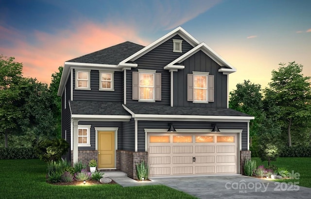 view of front of home with a lawn and a garage